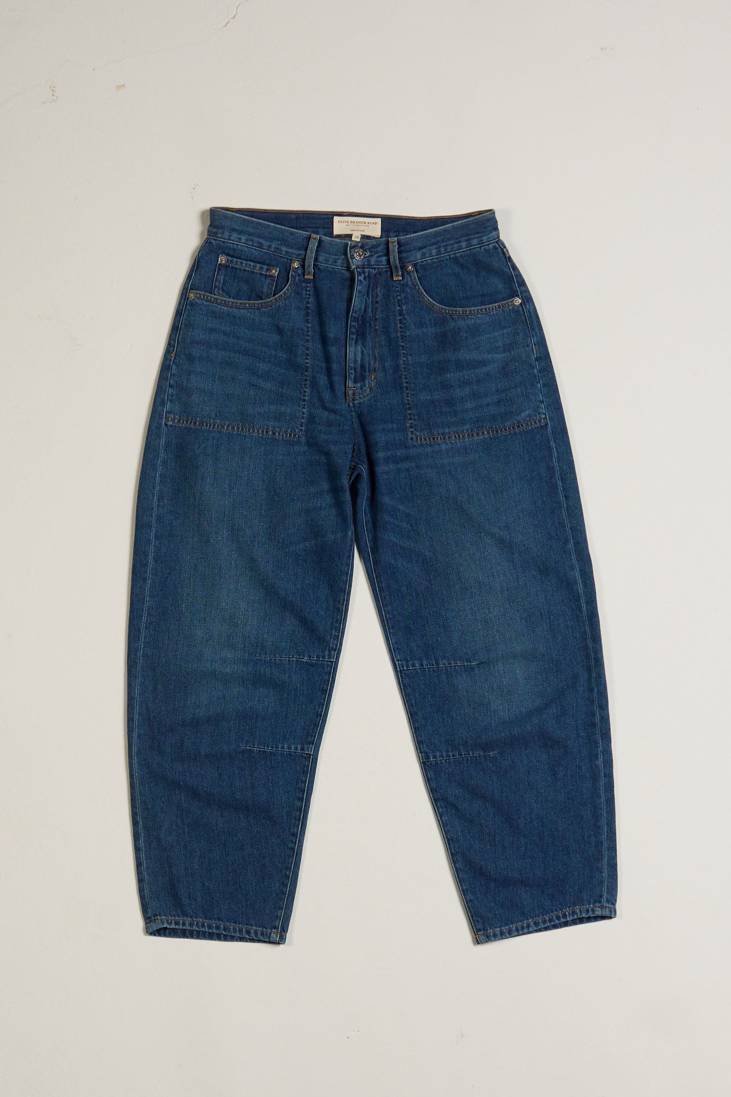 High-waisted, relaxed fit barrel leg Blue jeans on a white background