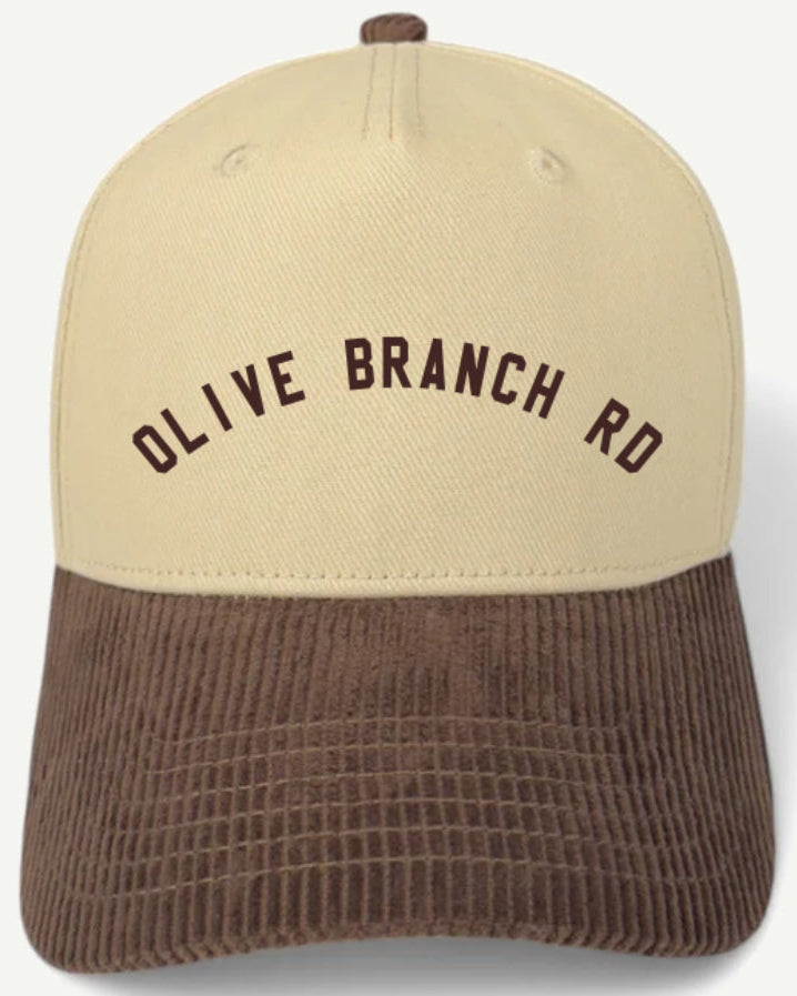 Beige and brown cap with 'OLIVE BRANCH RD' text on a white background