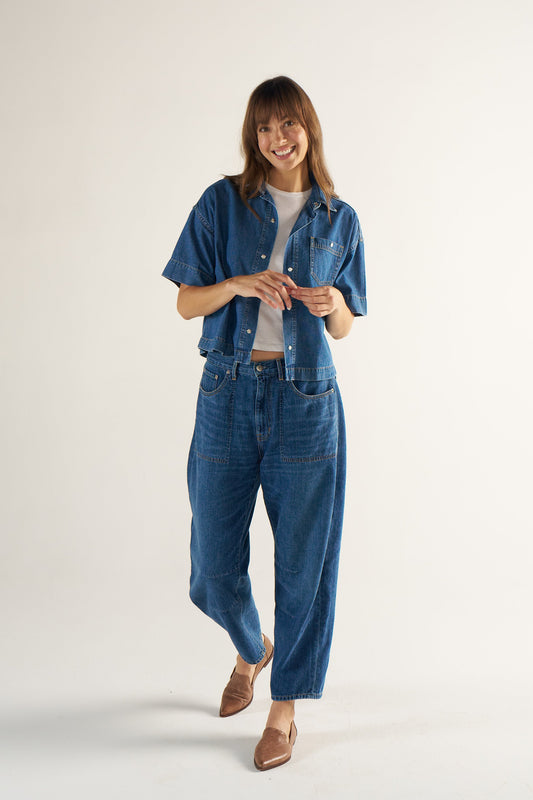 Woman wearing a denim outfit on a white background