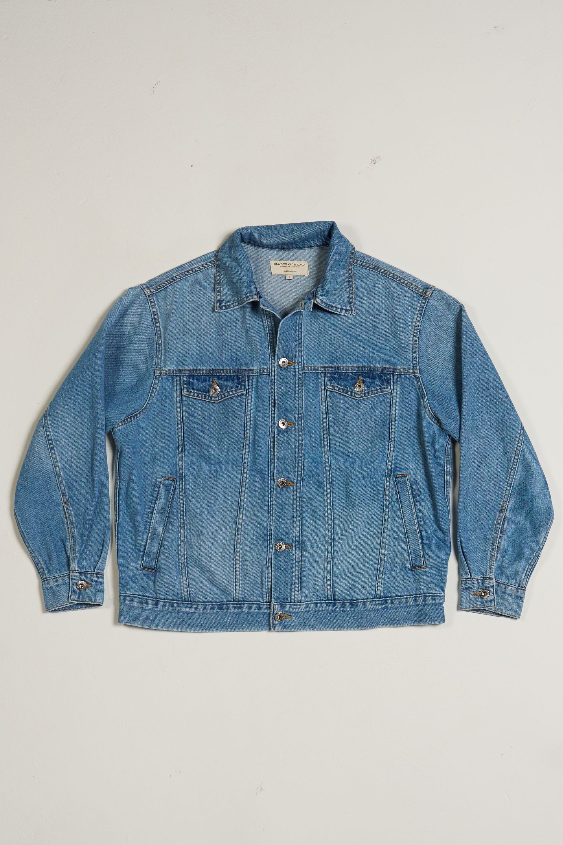 Blue denim jacket on a light gray background